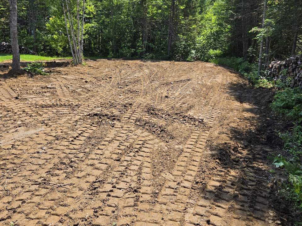 Cleared and levelled lot surrounded by trees