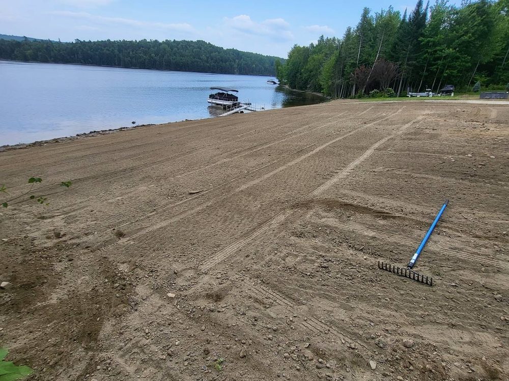Graded and raked lot beside a lake